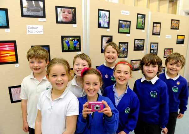 Children's photo exhibition at Amberley First School. Some of the children with their photos