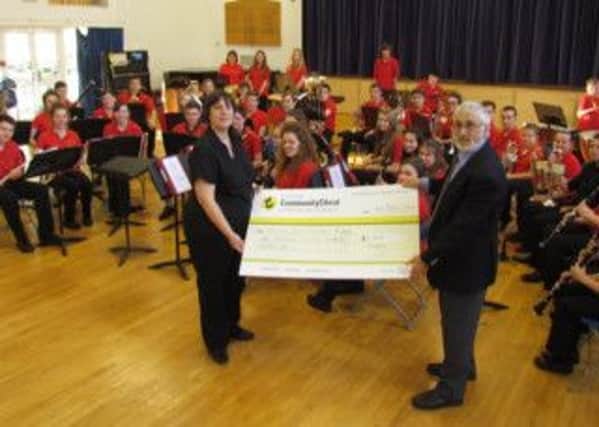 David Chapman presents Karen Kennard with a cheque from the Worthing Community Chest
