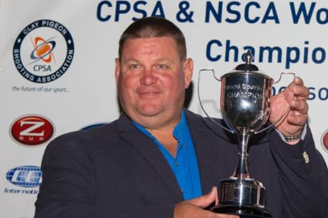 George Digweed, from Northiam, clutches the 2014 World English Sporting Championship clay shooting trophy