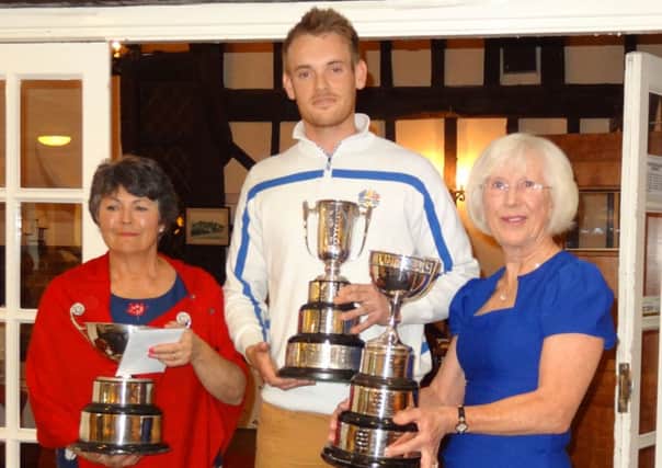 Wendy Melville (left) and Jack Martin (right) being presented with their cups by the Ladies Captain, Rosemary Parvin (centre).