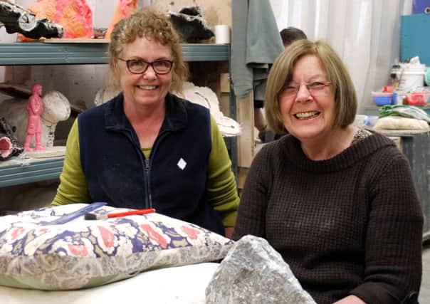Thea Taylor instructing a soft stone class, pictured here with Margaret Storey who was marking out and starting to transform stone into  a ladys face SUS-141205-153958001