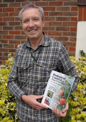 Neil Heler with the latest, revised version of his book Biological Control in Plant Protection SUS-141205-154347001