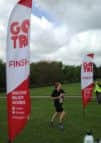 Lisa Fenn crosses the finishing line in the running event in the Horsham Go Tri aquathon SUS-140514-105643002