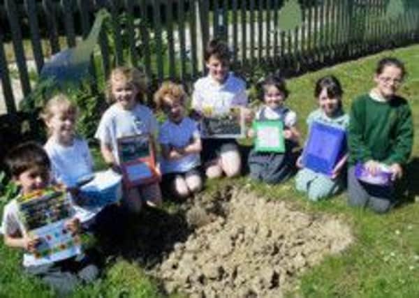 Dallington CE Primary School is celebrating its centenary. As part of the celebrations, the school has buried a time capsule. SUS-140514-153858001