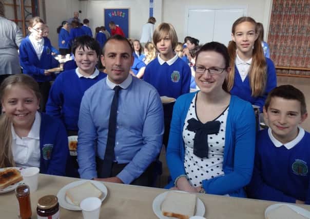 Store manager, Morgan Rees with Laura Nicholls head of year 6 and some of the year 6 children enjoying breakfast during SATS week SUS-140520-094110001