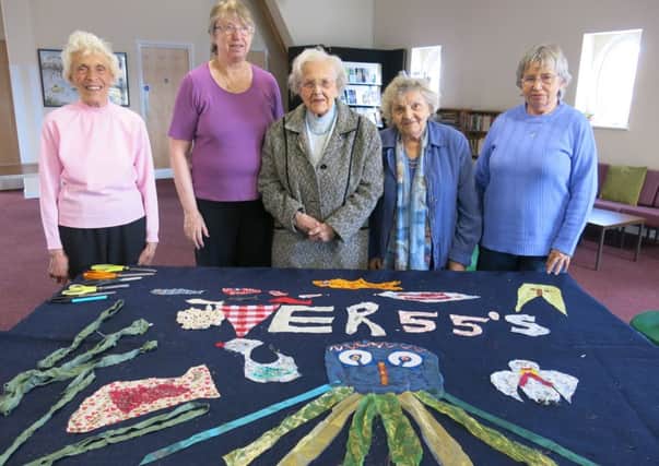 Members of the Fishersgate Over 55s Group with their banner