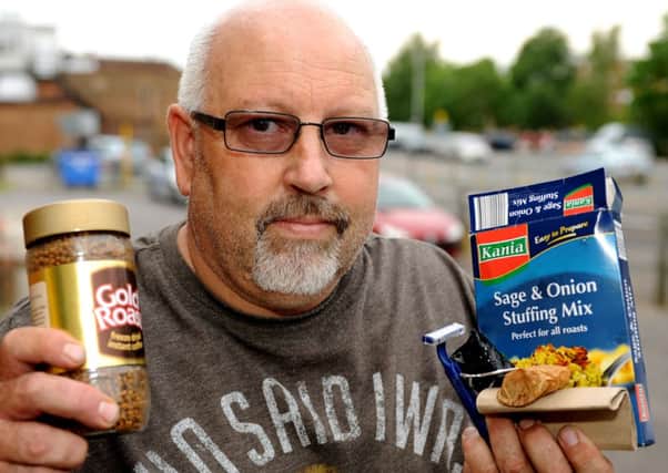 Chris Aldridge with some of the items found in food donated by Burgess Hill Community Food Bank Pic Steve Robards SUS-140522-110834001