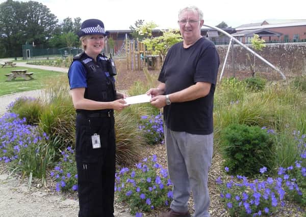 Cheque presented by Horsham police to Friends of Station Road Gardens in Billingshurst