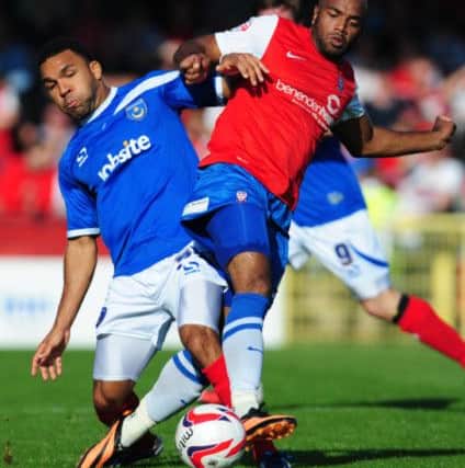 Portsmouth's Andy Barcham (left) and York City's Lanre Oyebanjo in action during the Sky Bet League Two match at Bootham Crescent, York. ENGPPP00220130410113359