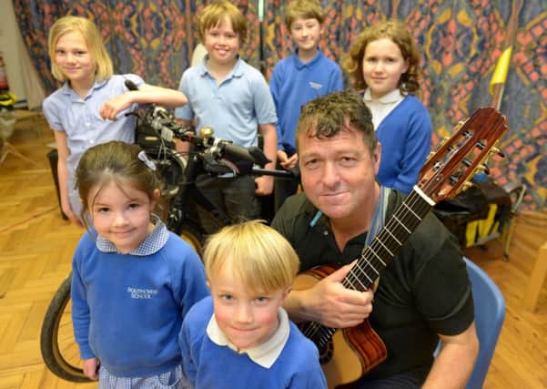 Guitarist Richard Durrant performs for children in Lewes on the second day of his tour