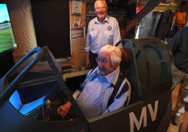 Former squadron leader and Probus club member Bill Lucas at the controls of the Wisborough Green Flight Simulator with trip organiser Ian Davis - picture submitted