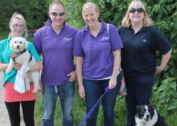 Bark in the Park Horsham St Catherine's Hospice: Mark Maltman and other representatives of Maltman Cosham with their dogs at the start line of Bark in the Park Horsham (submitted).