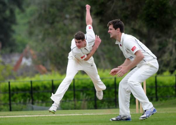 Horsham's overseas player Travis Muller bowling with captain Sam Attfield fielding. Pic Steve Robards