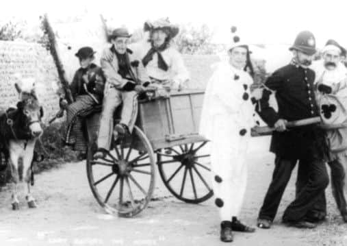 Putting the cart before the horse, with the village bobby, possibly Harry Legg, at the 1906 carnival