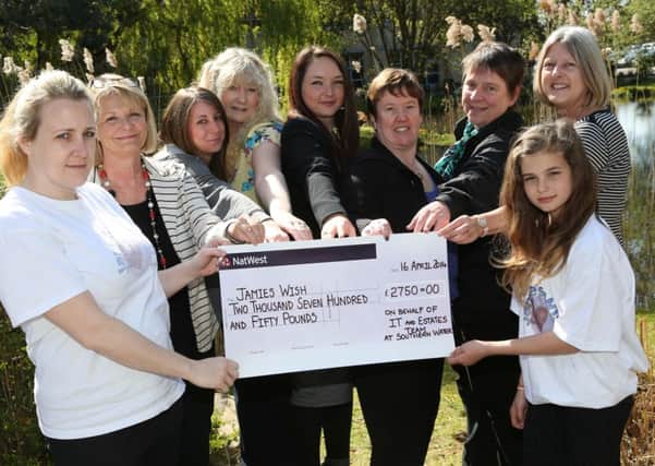 Southern Water employees present representatives from Jamies Wish Trust with a cheque for £2,750. SUS-140306-152024001