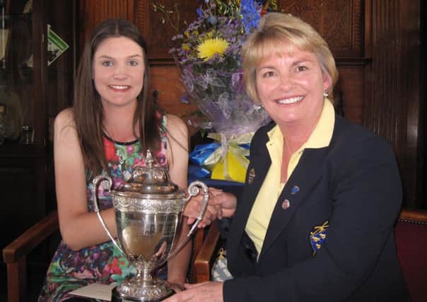Alice Barnes receiving her trophy from Daisey Kane