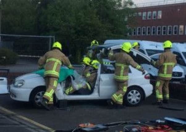 Firefighters cut County Times reporter Harley Tamplin out of a car