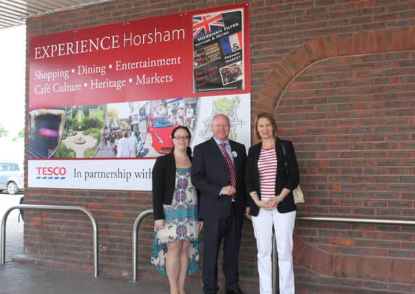 Pictured with the Experience Horsham poster, Tesco Customer Services Manager Louise Sharman, Store Manager Lee Laflain, and HDC cabinet member Helena Croft