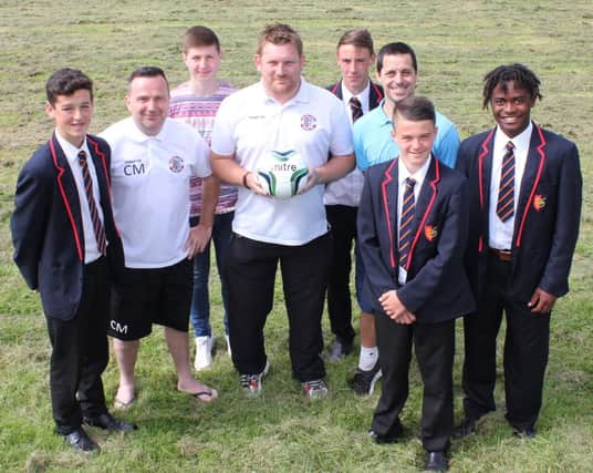 Hastings United coaches join ARK William Parker Academy staff and pupils to celebrate the announcement of a new under-19 football academy