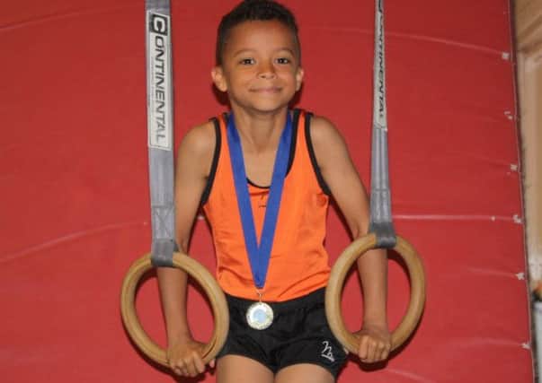 Summerfields Gymnastics Club starlet Phoenix Williams with the gold medal he won at an all-boys' event in Dover