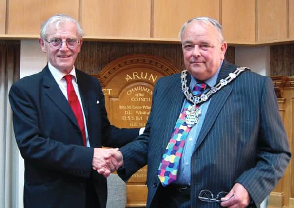 Councillor Terence Chapman hands over his chain of office to Arun District Council's new chairman councillor Dougal Maconachie SUS-141206-150031001
