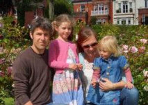 Isobelle Scott, five, with her dad Josh, mum Sarah and younger sister Florence