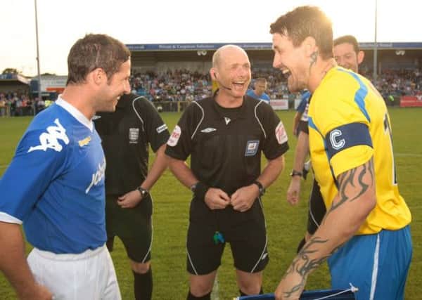 Ref Dave Phillips shares a joke with the Hawks' Lee Peacock (R) and Pompey's David Norris Picture by Dave Haines