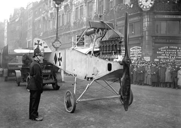The fuselage of a German LVG CII biplane, captured in France, is paraded along Fleet Street as a trophy in 1916. SUS-140617-070216001