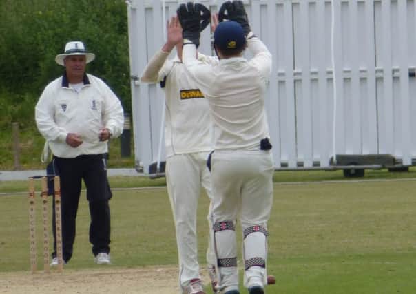 Hastings Priory duo Elliot Hooper and Jake Woolley celebrate a wicket in the Gray-Nicolls Sussex T20 Cup tie at home to Horsham on Sunday. Picture by Simon Newstead (SUS-140615-184339002)