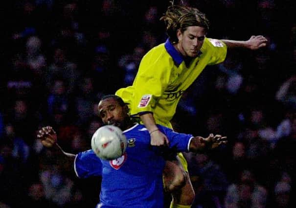 Richard Rose (yellow strip) in action for Gillingham against Portsmouth