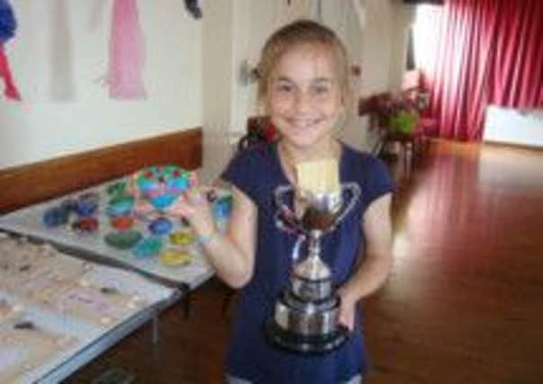 Staplecross Primary School pupil Martha Hollamby, 10, pictured with the Sunderland Cup and her winning painted pebble. SUS-140626-085839001
