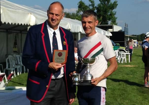 Bexhill Rowing Club talent Mark Mitchell receiving his trophy from Sir Steve Redgrave