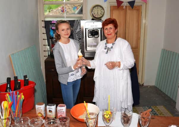 Fiona Ayres who has opened a pop-up ice cream parlour in Henfield with satisfied customer Evie Sherriffs - picture submitted