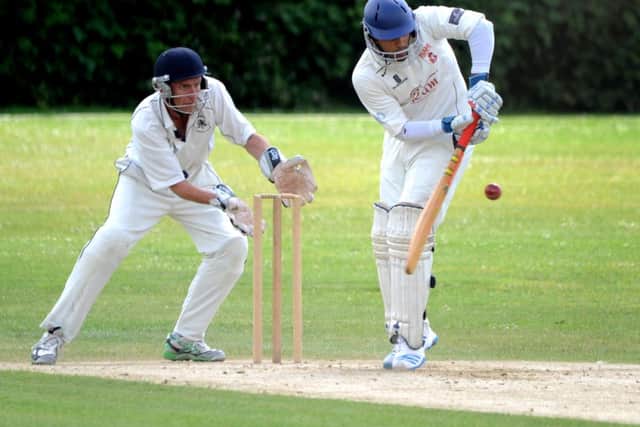 St Andrews (fielding) v Rams I. Wicket keeper Paul Brindle and batsman Hashil Patel. Pic Steve Robards SUS-140630-112156001