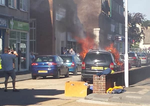Members of the public watched on as a car went up in flames