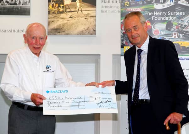 John Surtees OBE, has presents the £75,000 cheque to charity Kent, Surrey & Sussex Air Ambulance SUS-140707-121537001
