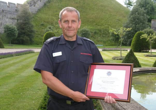Retained firefighter Mark Dunham standing proudly after serving the community of Arundel for 31 years