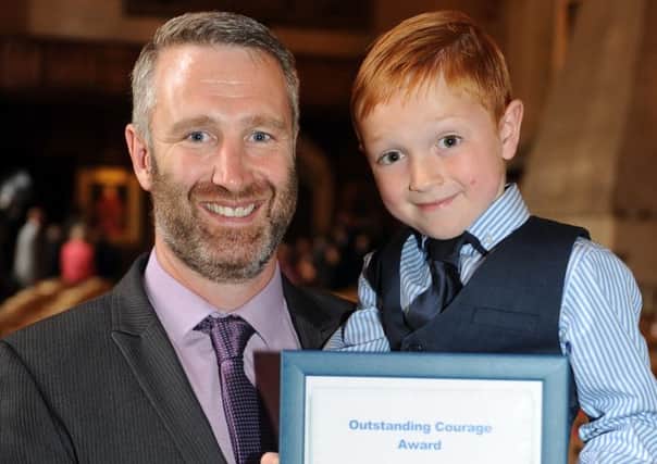 070714 Police Awards. Peter Downes, with son Jack 6. Outstanding courage award for tackling a thief iin Horsham. Photo by Derek Martin SUS-140807-093738001