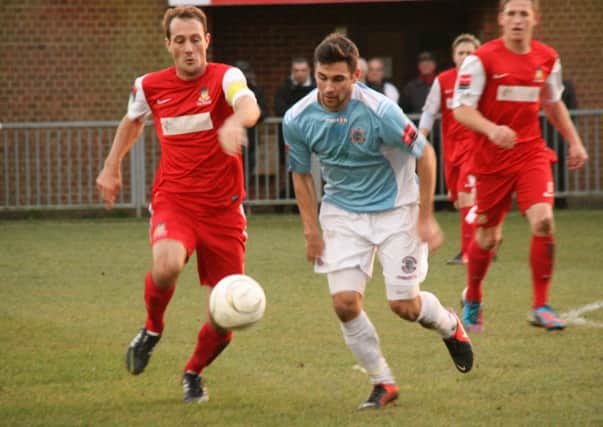 Ronnie Dolan (blue shirt) in action for Hastings United away to Worthing last season. Picture by Terry S. Blackman