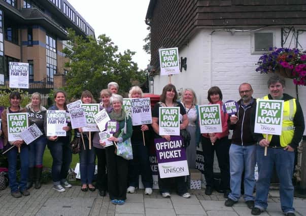 West Sussex County Council workers strike outside County Hall North, Horsham, as part of Unison's protest againt the Government pay deal SUS-141007-122713001