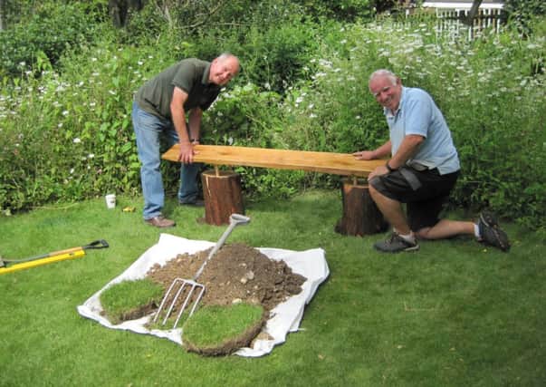 Work to install a new rustic-style bench in Littlehampton's Mewsbrook Park SUS-141007-141008001