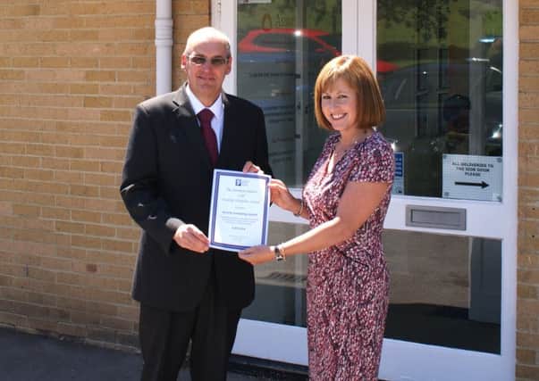 Sue Rogers, Horsham District Council cabinet member for a healthier and safer district presenting a gold Healthy Workplace award to Assurity Consulting managing director Paul Foxcroft - submitted by HDC