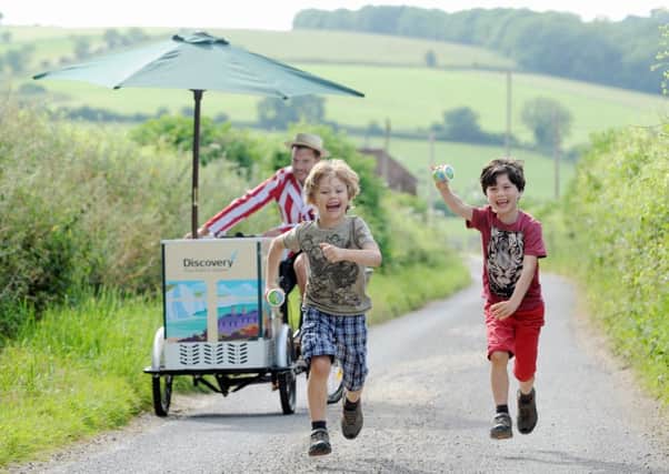 Drew and Arran enjoy an exclusive Discovery ice cream as they run for the bus in the South Downs SUS-141107-154718001