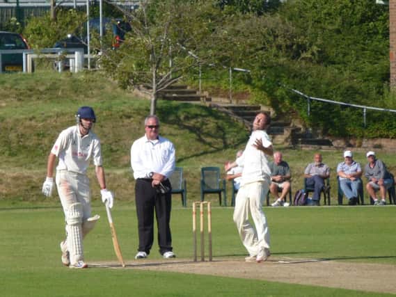 Hastings Priory captain George Campbell bowling against Roffey. Picture by Simon Newstead (SUS-140713-220836002)