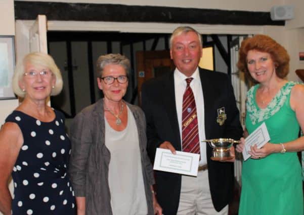 Picture shows, from left:  Ladies Captain, Rosemary Parvin, and Jo Watters presenting the winners, Club Captain, Derek May and his wife Kathy, with the Bill Watters Quaich and their prizes.