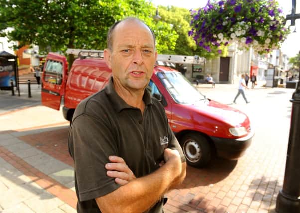 WH 150714  Window cleaner Oliver Plowman has appealed an 'unfair' parking ticket he received while cleaning windows in the town centre