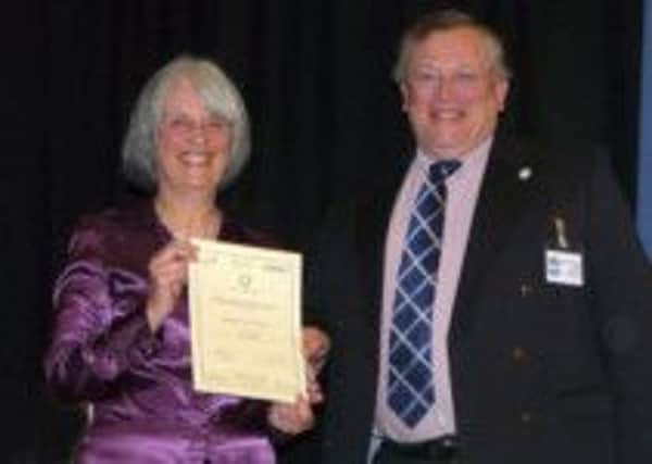 Pauline Raymond, Parish Clerk, being presented with the Quality Council Re-accreditation Certificate by David Young of Sussex Association of Local Councils SUS-140716-141738001