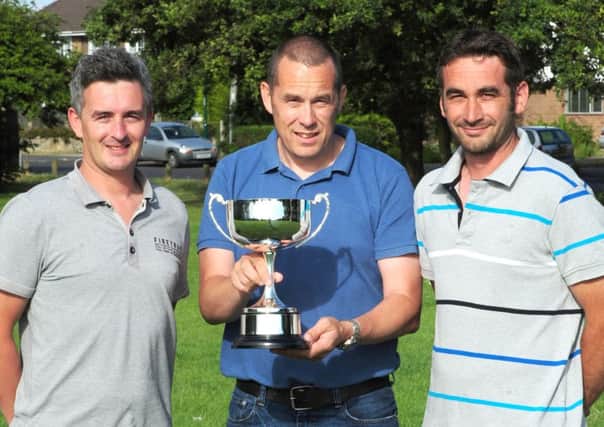 John Wickenden, left, Darren Holden, and Matthew Parkes with the memorial trophy for their friend David Knowles Picture by Kate Shemilt C140755-2