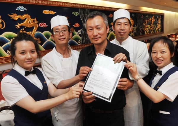 W29594H14  China Palace owner Victor Hang and his team with their new five-star certificate