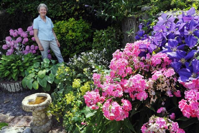 S29552H14
Beeding in Bloom Pat Nightingale in the Back Garden of 13 Deacon Way SUS-140717-170306001